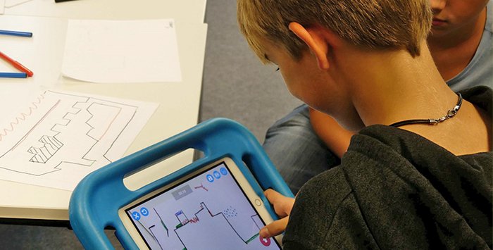 Junge bedient Tablet mit dicker blauer Hülle